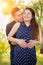 Affectionate Hispanic Pregnant Young Couple Portrait Outdoors