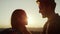 Affectionate man looking in woman eyes. Couple standing on top of mountain