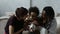 Affectionate mixed race parents kissing little son
