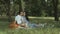 Affectionate pregnant family enjoying picnic in park