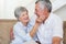 Affectionate retired couple sitting on the sofa