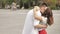 Affectionate young couple embracing and sharing a romantic kiss while standing together on a street in the city