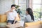 Affectionate young couple having brunch together at morning, enjoying friendly talk near window, drinking coffee