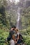 Affectionate young couple standing together in forest