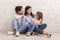 Affectionate Young Family Bonding Together While Sitting On Floor At Home