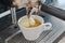 Affogato coffee with ice cream on a ceramic cup with coffee pouring from espresso machine