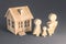 affordable housing Mortgage loan symbol - Young parents and a child are standing near their home