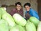 Afghan boys smile with watermelons in market