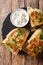 Afghan fried flat breads with potatoes, green onions and cilantro closeup. Vertical top view