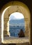 Afghan Muslim sits in an archway overlooking city of Kabul from damaged tomb of Sultan Mohammed Khan Telai, former Afghan king.