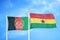 Afghanistan and Ghana  two flags on flagpoles and blue cloudy sky