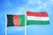 Afghanistan and Hungary  two flags on flagpoles and blue cloudy sky