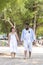 Afircan American Black man hold hand Asia Woman lover honeymoon time on sea beach - outdoor summer beach concept