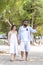 Afircan American Black man hold hand Asia Woman lover honeymoon time on sea beach - outdoors summer beach concept