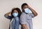 Afraid Black Couple Wearing Protective Masks And Holding Head With Hand