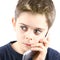 Afraid little boy speaking on the phone in white background