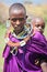 Africa, Tanzania - February 2016: Little baby behind the mother. Masai tribe.