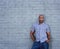 African america man standing against a gray wall