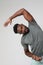 African American athletic man doing muscle stretching exercises. Vertical.