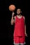 African american basketball player posing and balancing ball
