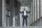 African american boss celebrating victory and successful achievement, businessman dancing on stairs of modern office