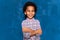 African american boy child make face on blue background