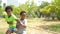 African American boy and girl pulling a rope together in tug of war competition - brother and sister on leisure activity