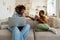 African American boy kid asking attention from busy mother freelancer while sitting on sofa at home