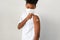African-American boy showing adhesive bandage on shoulder after getting vaccinated during coronavirus or covid-19 pandemic at hosp