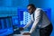 African-American broker works in office using workstation and analysis technology. Workplace of professional trader