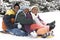 African American brothers and sister sliding on a sled.