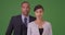 African American business professionals pose for a portrait on green screen