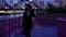 African American business woman walking along a bridge at night wearing a fashionable business black dress.