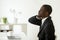 African-american businessman feels stiff neck joint pain after s