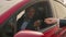 African american businessman inside his luxury electric car. Handsome man looks satisfied with successful purchase