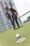 African American Businessman Playing Rooftop Golf