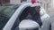 African american businessman with santa hat looking through the window of his car