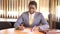 African american businessman signs documents while sitting at the negotiation table in the office