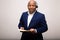 African American Businessman Smiles While Holding File