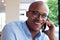 African american businessman smiling and talking on mobile phone