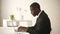 African American businessman working on computer sitting at office desk