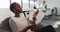 African american businesswoman working in armchair while her coworker having a business call