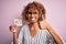 African american call center agent woman using headset holding reminder with yes message happy with big smile doing ok sign, thumb