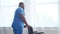 African-American caregiver and an empty wheelchair. Professional nurse in a nursing home. Assistance, rehabilitation and