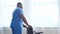 African-American caregiver and an empty wheelchair. Professional nurse in a nursing home. Assistance, rehabilitation and