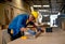 African American carpenter man use pencil to mark on timber during work with in wood factory workplace