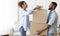 African American Couple Carrying Out Boxes Leaving Old Apartment