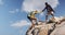 African american couple climbing on the rocks while trekking