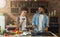 African-american couple cooking dinner and drinking red wine