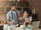 African-american couple cooking pastry with recipe on laptop